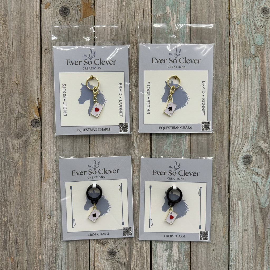 Four packages of Ever Clever charms on a wood background