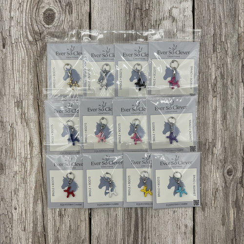 Packaged Ever So Clever balloon dog charms on wood background. 