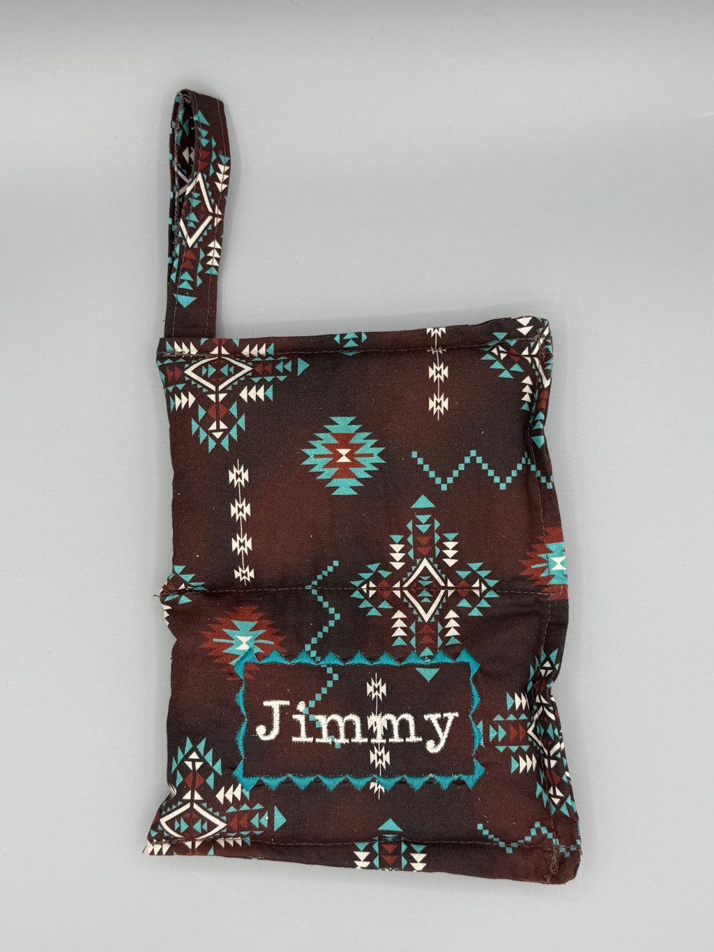 Brown Aztec horse bit warmer open with outside displayed