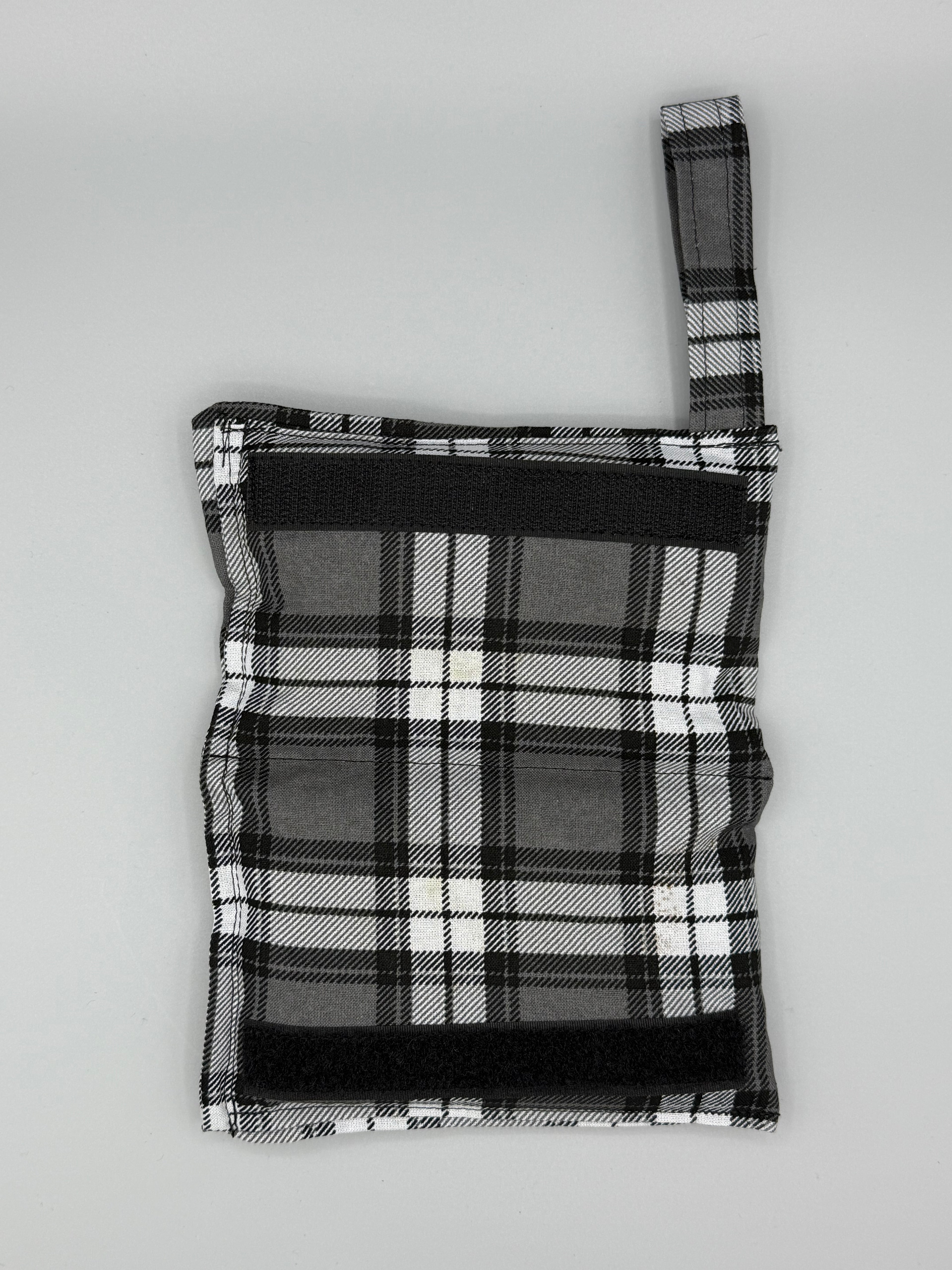 Charcoal Plaid horse bit warmer open with velcro inside displayed