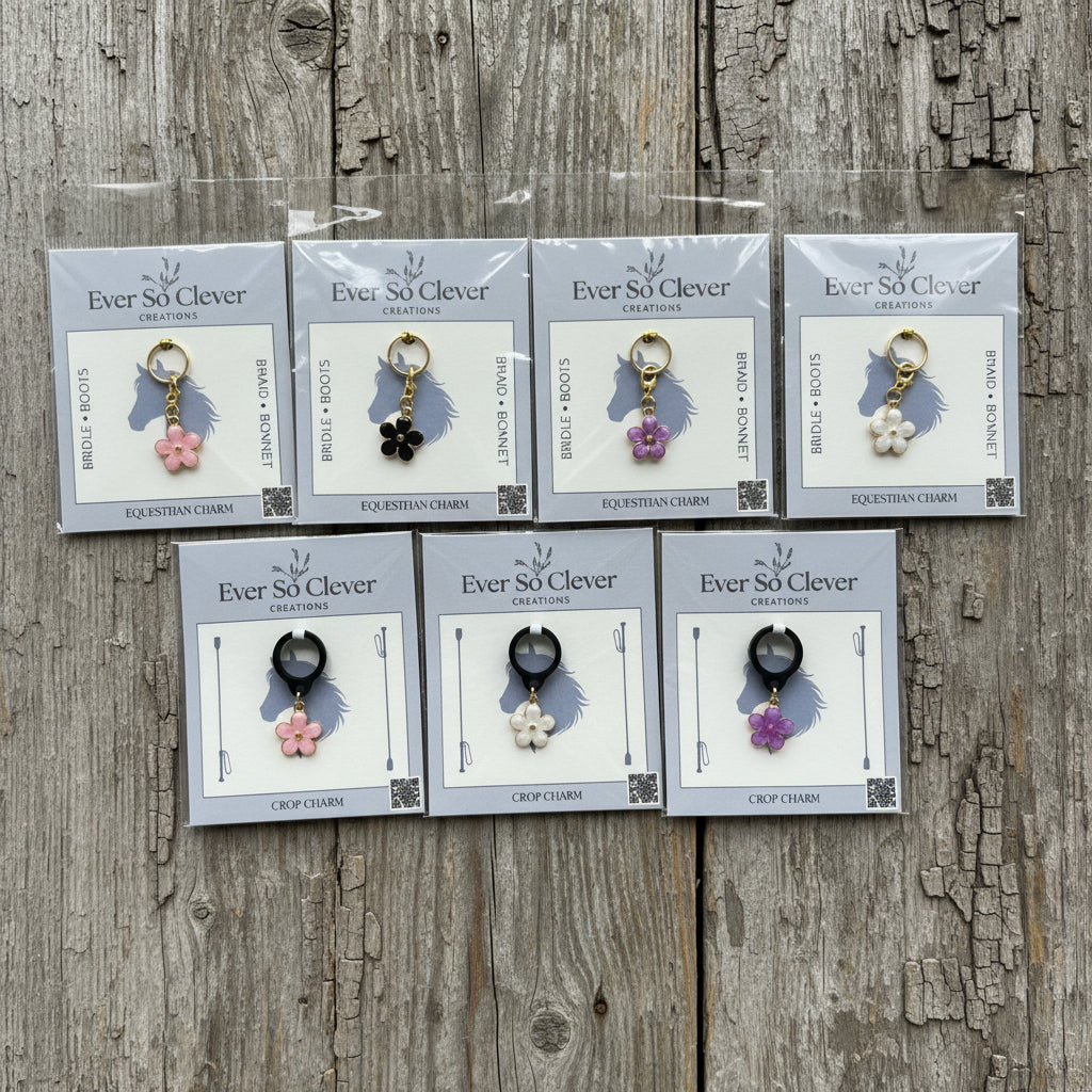 Collection of equestrian charms  in packaging on a wood background