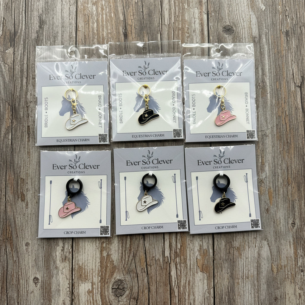 Packages of cowboy hat charms on wood background