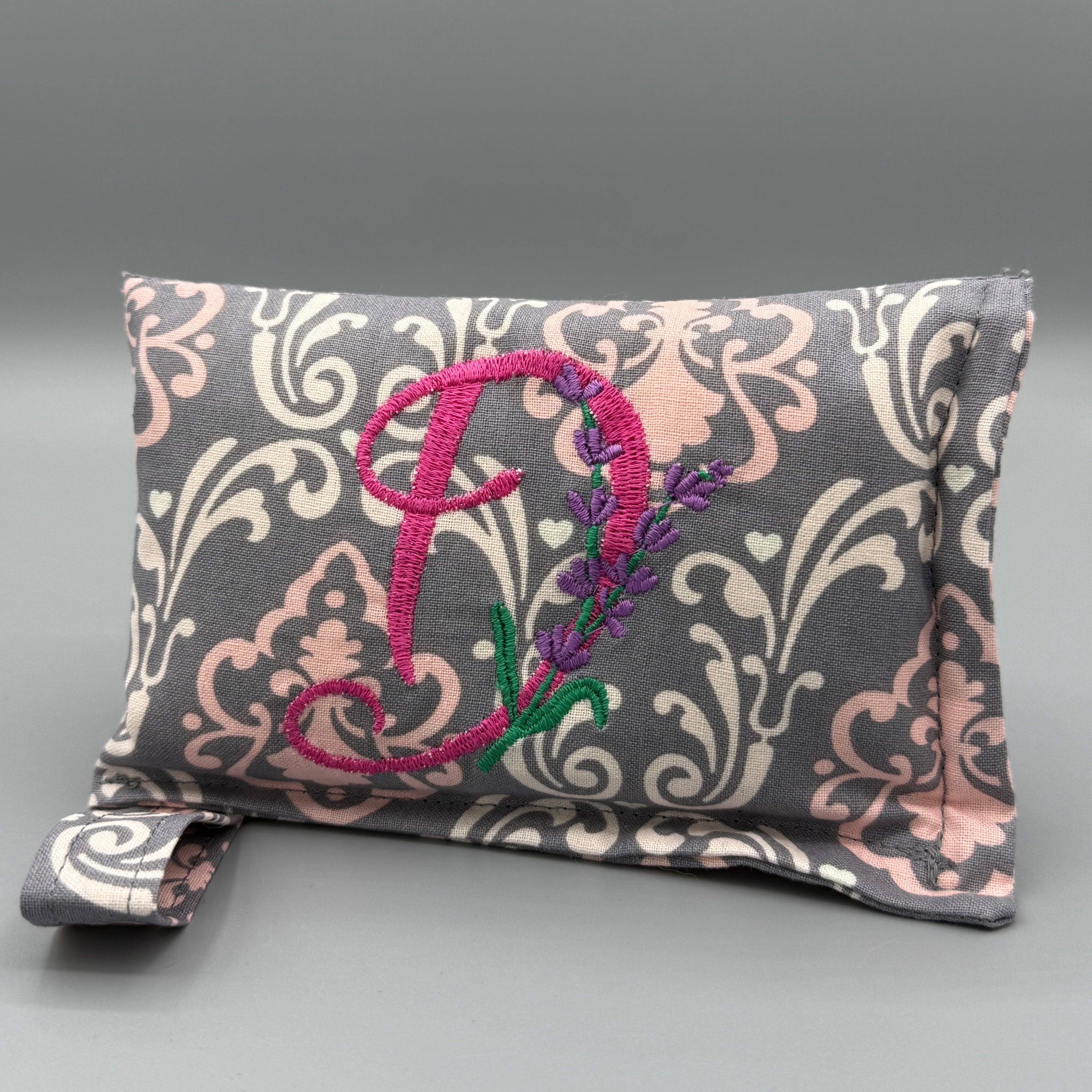 Divine Damask horse bit warmer with "D" personalization on grey background