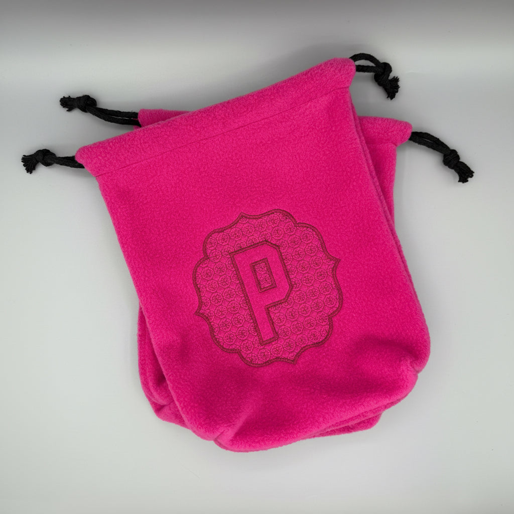 Hot Pink stirrup covers with embossed 'P' monogram on gray background. 
