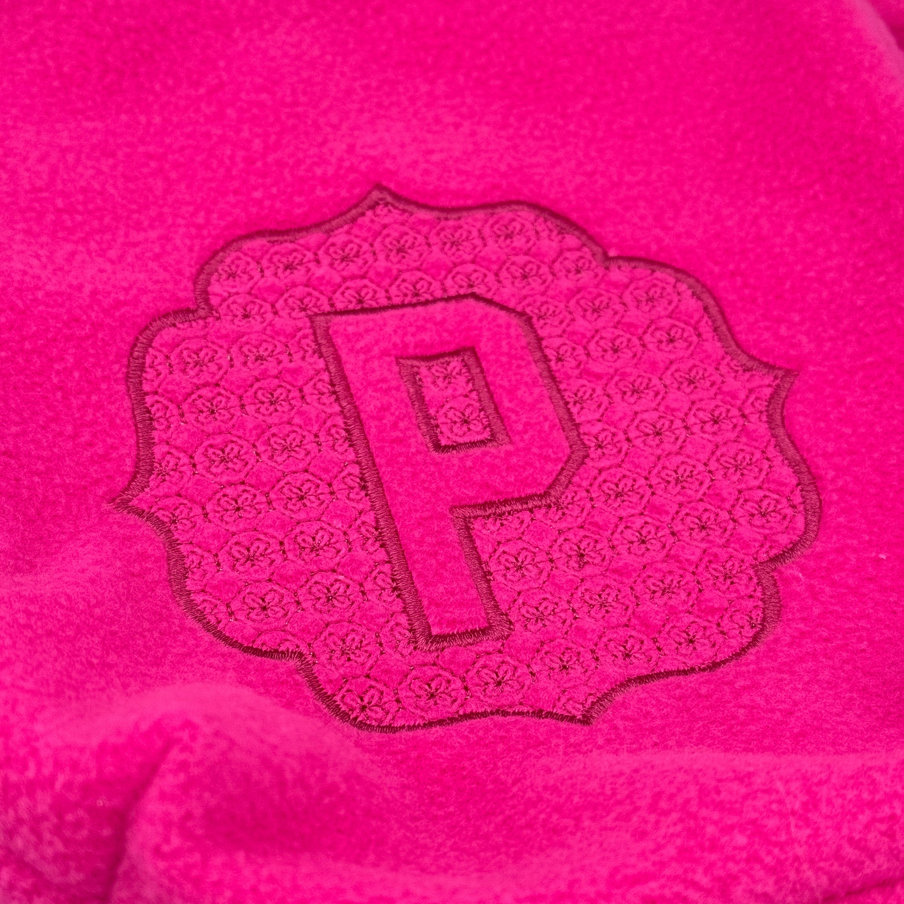 Close up of embossed 'P' monogram on Hot Pink stirrup cover. 