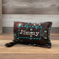 Brown bit warmer with tribal patterns and 'Jimmy' personalization on wooden background