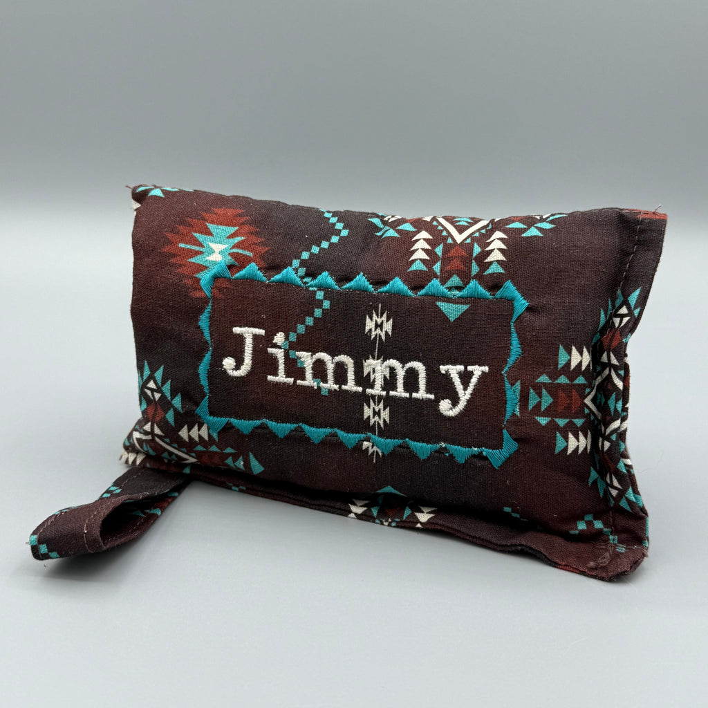 Brown Aztec horse bit warmer with Jimmy personalization on grey background 