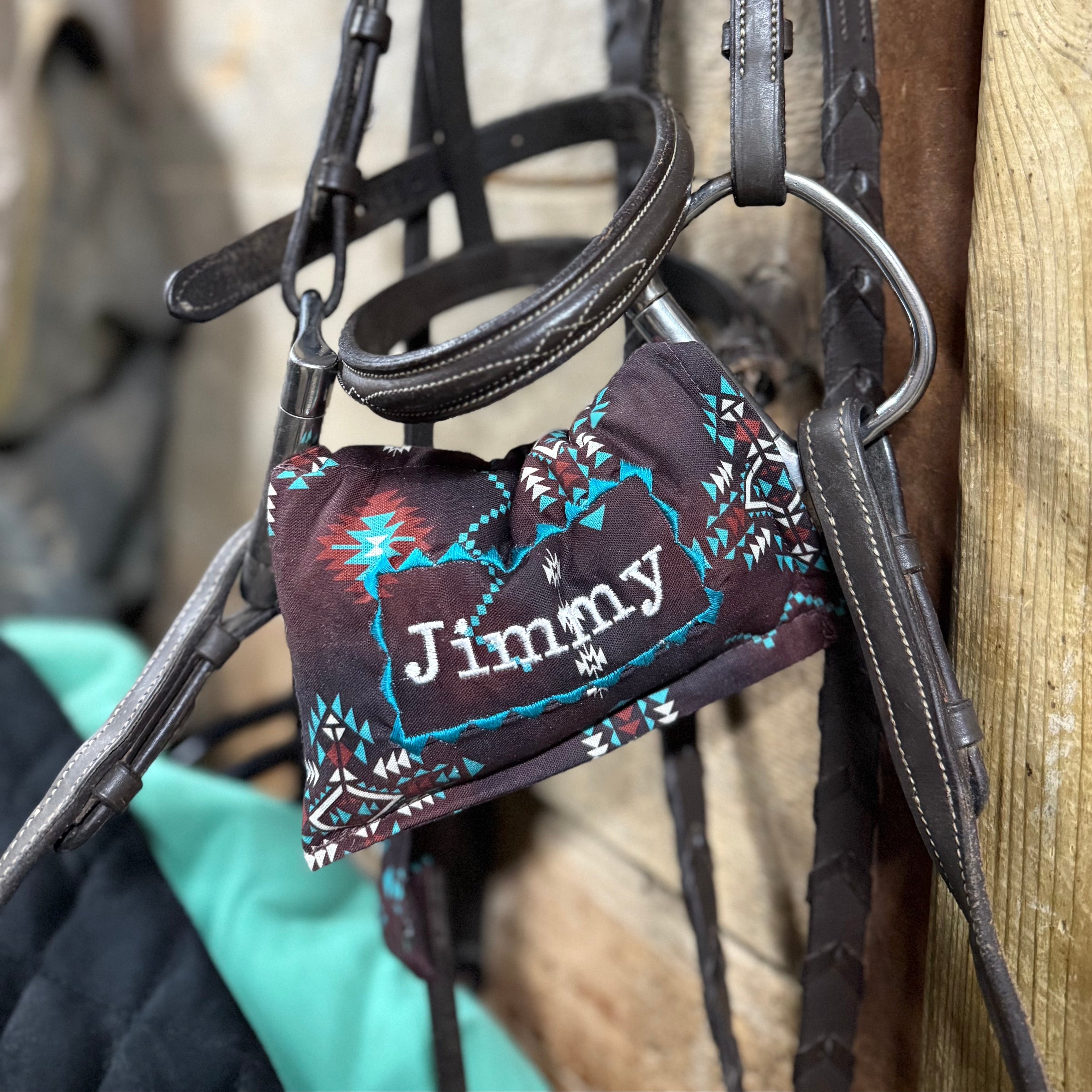 Brown Aztec  horse bit warmer with Jimmy personalization on hanging bridle
