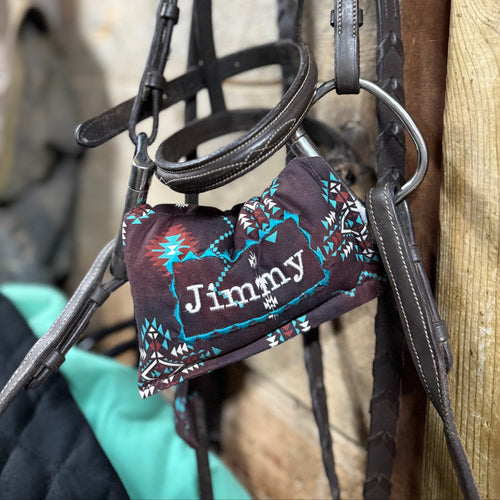 Brown Aztec  horse bit warmer with Jimmy personalization on hanging bridle
