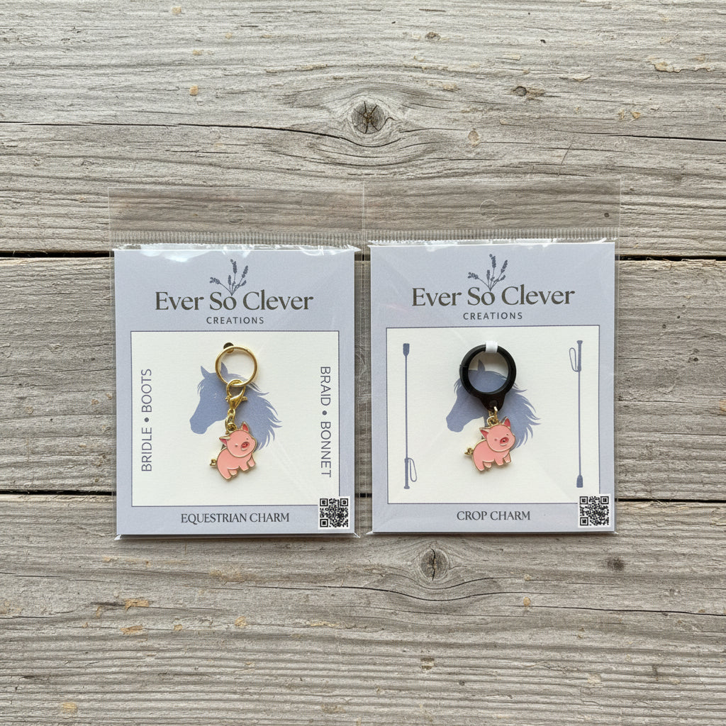 Packages of little pig charms on wood background