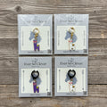 Four packages of Ever So Clever Creations lovely llama charms on wood background