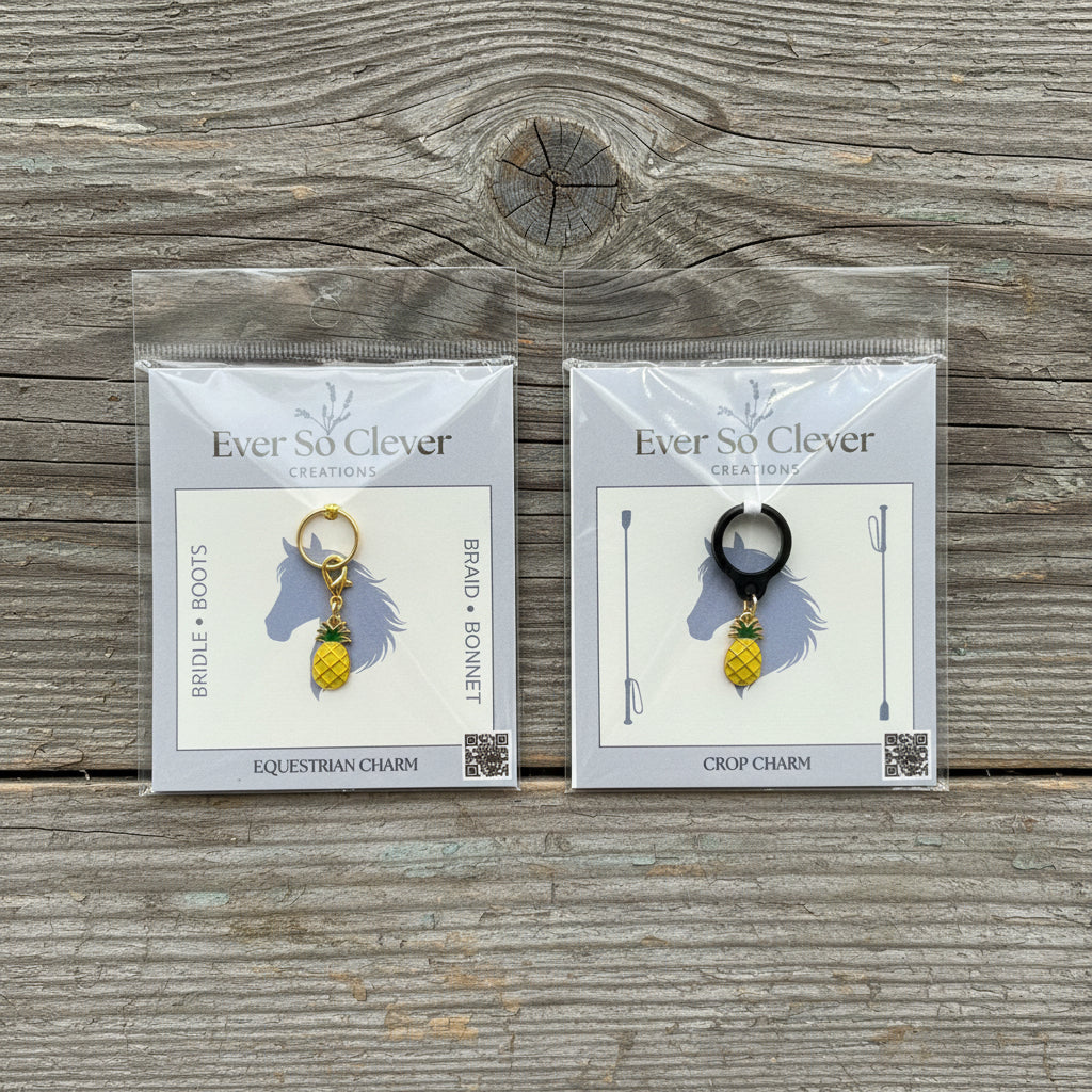 Two packages of Ever So Clever charms on a wood background